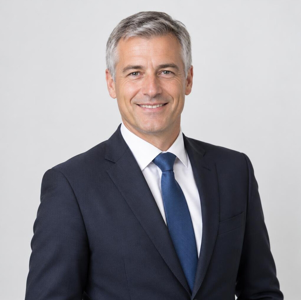Portrait of a man in a dark suit with a neutral background
