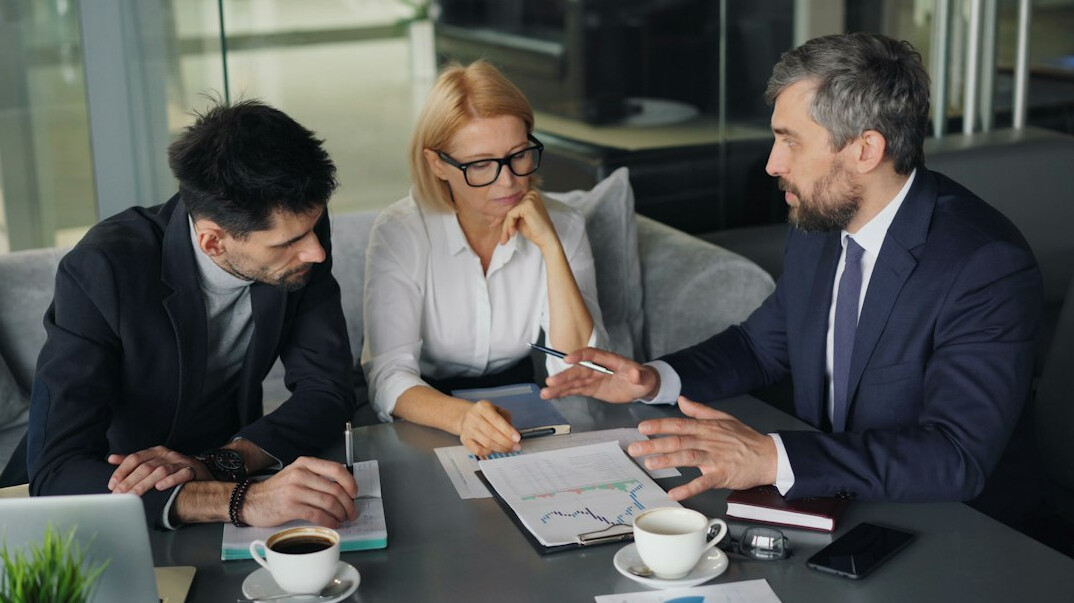 business manager leading team meeting